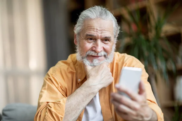 Cheerful Handsome Senior Man Sitting Couch Home Using Modern Smartphone — Stock Photo, Image