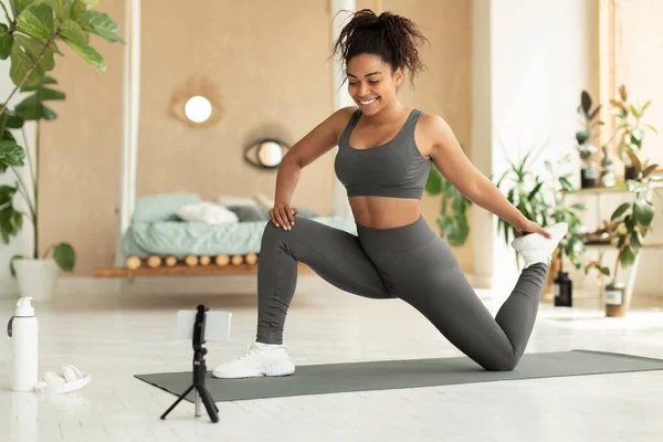 Black Female Fitness Blogger Stretching Front Smartphone Home Shooting Video — Stok fotoğraf