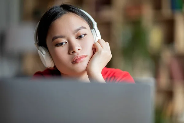 Sad Boring Adolescent Asian Lady Student Headphones Watching Video Lesson —  Fotos de Stock