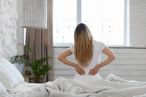 Unrecognizable Blonde Lady Suffering Back Pain Bedroom Waking Morning Sitting — Stok fotoğraf