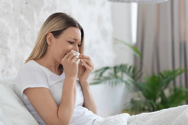 Ill Unhappy Blonde Millennial Lady Pajamas Sitting Bed Home Sneezing — Stock Photo, Image