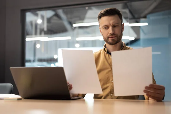 2010 Serious Male Entrepreneur Doing Paperwork Holding Two Papers Reading — 스톡 사진