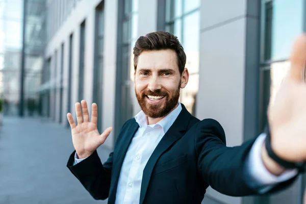 Happy Confident Handsome European Millennial Bearded Businessman Takes Selfie Waving — Stock Fotó