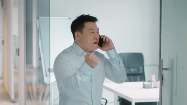 Positive Phone Talk Indoors Portrait Emotional Middle Aged Asian Man — Stockvideo