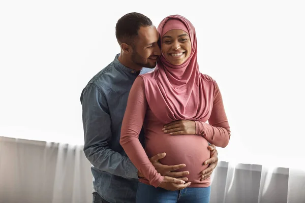 Portrait Loving Happy Black Islamic Spouses Expecting Baby Posing Home — Zdjęcie stockowe
