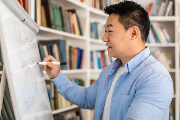 Happy Korean Male Teacher Writing Whiteboard Having Lecture Standing Classroom — Foto de Stock