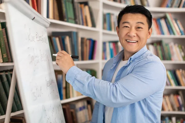 Cheerful Japanese Tutor Man Smiling Camera Writing Whiteboard Teaching Having — Stockfoto