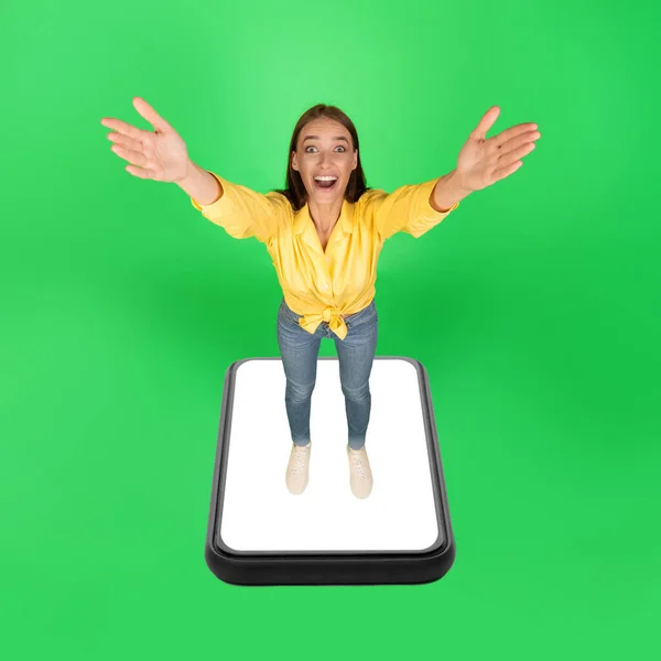 Excited Woman Standing Huge Smartphone Screen Stretching Arms Camera Posing — ストック写真