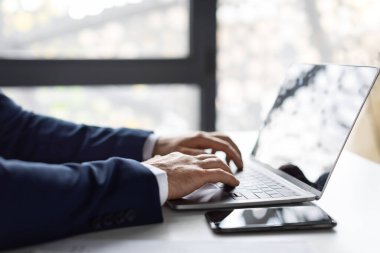 Closeup Shot Of Hands Of Unrecognizable Businessman In Suit Working On Laptop While Sitting At Desk In Office, Male Entrepreneur Typing On Computer Keyboard At Workplace, Side View Shot, Cropped