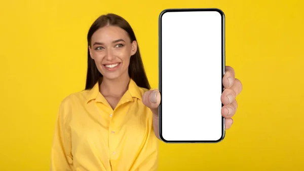 Happy Woman Showing Phone Blank Screen Smiling Camera Standing Yellow —  Fotos de Stock