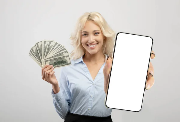 Smiling Young Woman Holding Big Blank Smartphone White Screen Money — Foto de Stock