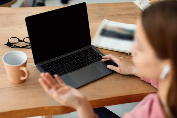 Schoolgirl Using Laptop Blank Screen Gesturing While Talking Webcamera Sitting — Fotografie, imagine de stoc