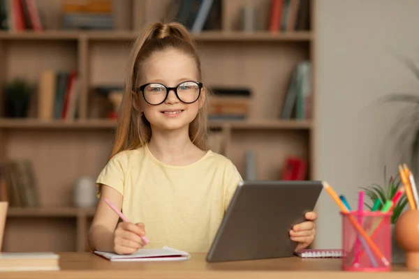 Schoolgirl Taking Notes Using Digital Tablet Posing Smiling Camera Sitting — 图库照片