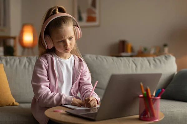 Unhappy Schoolgirl Learning Online Laptop Computer Taking Notes Doing Homework — Fotografia de Stock