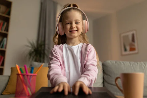 Happy Kid Girl Typing Laptop Wearing Pink Headphones Smiling Camera — Fotografia de Stock