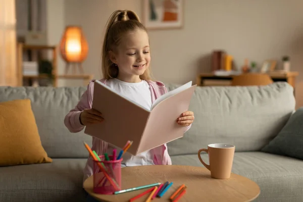 Cheerful Schoolgirl Reading Book Doing Homework Home Happy Kid Girl — Stock fotografie