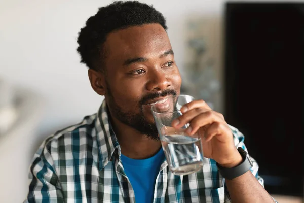 Happy Millennial African American Man Drinking Water Holding Glass Looking — Stock Fotó