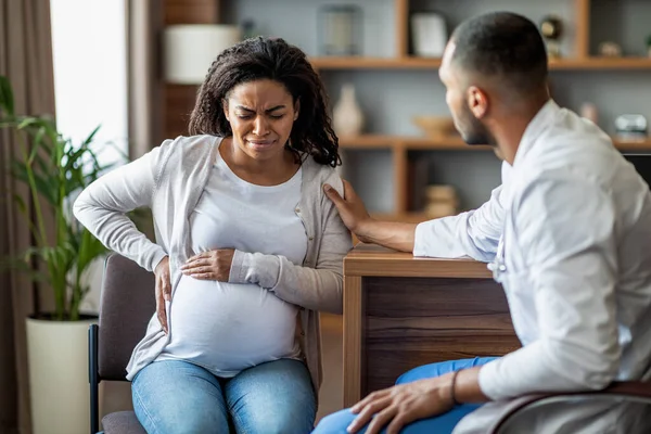 Pregnant Young Black Woman Suffering Pain Sitting Chair Touching Her — Foto de Stock