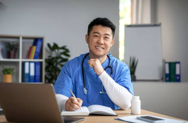 Cheerful Young Korean Male Doctor Uniform Stethoscope Workplace Work Laptop — Stock Photo, Image