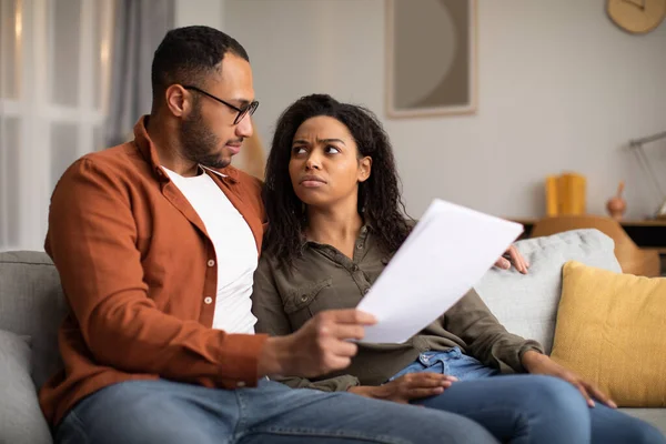 Concerned African American Couple Holding Papers Reading Bills Having Problems —  Fotos de Stock