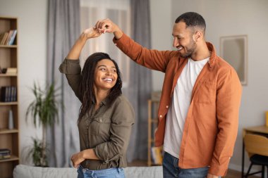 Romantic Relationship. Cheerful Black Spouses Dancing Having Fun Spending Time Together During Date At Home On Weekend. Happiness And Joy In Marriage Concept