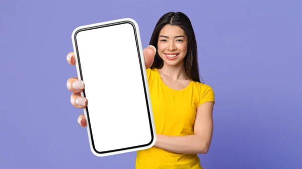 Look Positive Millennial Korean Woman Showing Mobile Phone White Blank — Zdjęcie stockowe