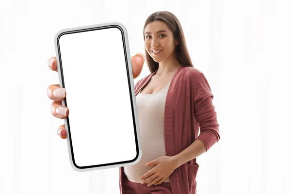 Portrait Smiling Young Pregnant Woman Holding Smartphone White Empty Screen — Stockfoto