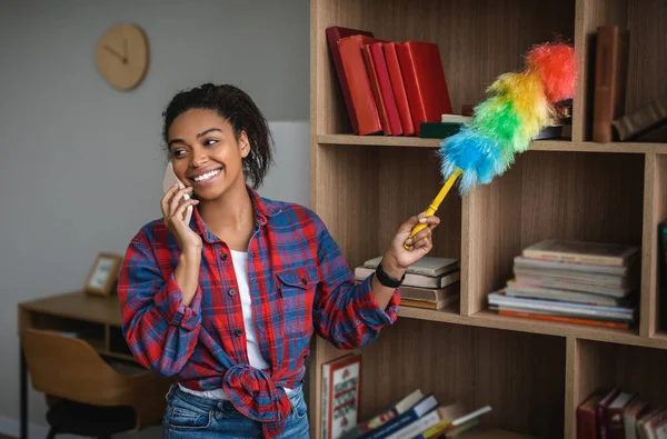 Smiling Millennial African American Housewife Wiping Dust Calling Phone Room —  Fotos de Stock