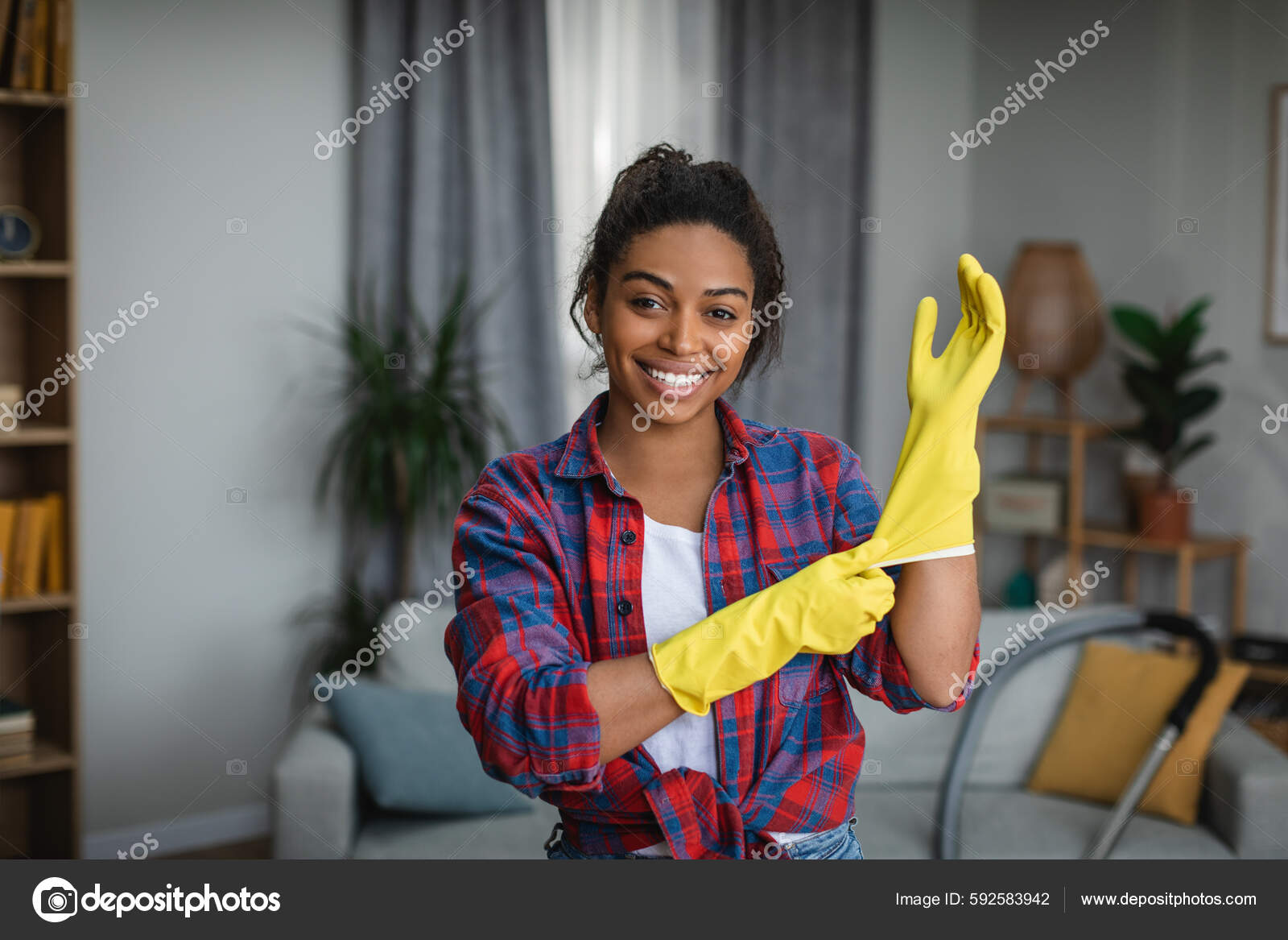 Smiling Young African American Woman Puts Rubber Gloves Ready