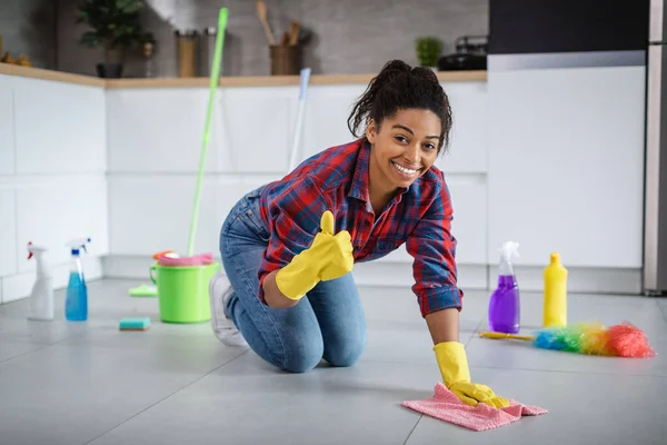 Cheerful Millennial Young African American Housewife Rubber Gloves Washes Floor — стоковое фото