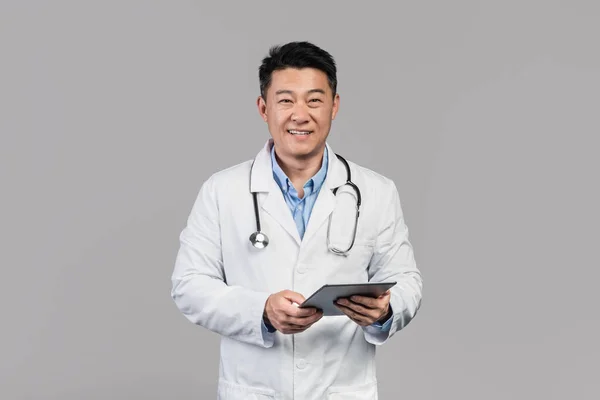 Cheerful Middle Aged Asian Male Doctor White Coat Stethoscope Tablet — Fotografia de Stock