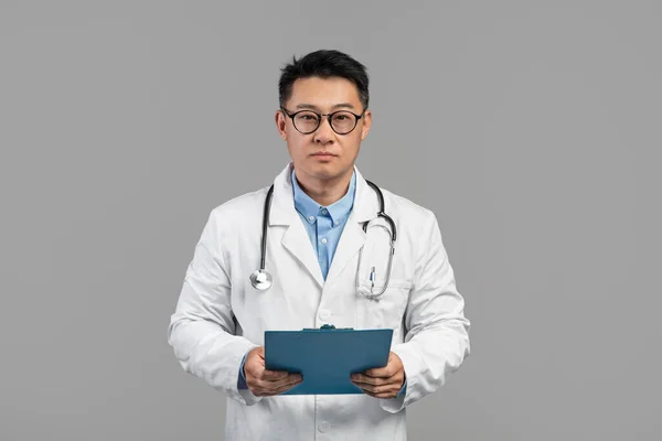 Serious Mature Japanese Doctor White Coat Glasses Stethoscope Tablet Isolated — Stock Photo, Image