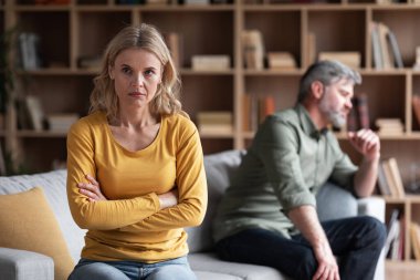 Marital Crisis. Upset Middle Aged Womam Sitting Offended After Argue With Husband At Home, Depressed Pensive Lady Tired Of Domestic Conflicts With Spouse, Suffering Crisis In Relationship