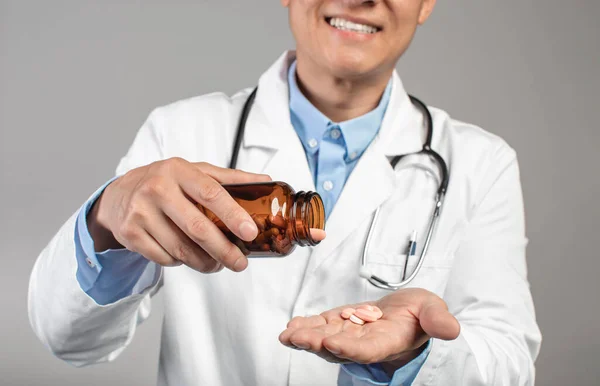 Cropped Smiling Mature Asian Doctor White Coat Pours Pills Jar — Stok Foto