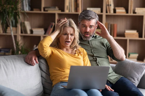 Online Scam Emotional Middle Aged Couple Looking Laptop Screen Shock —  Fotos de Stock