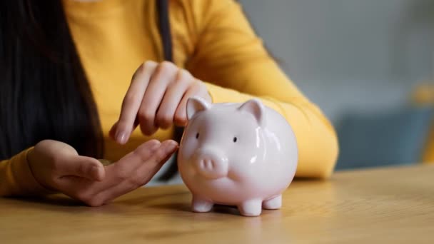 Money Saving Concept Close Shot Unrecognizable Woman Putting Coins Piggy — стоковое видео