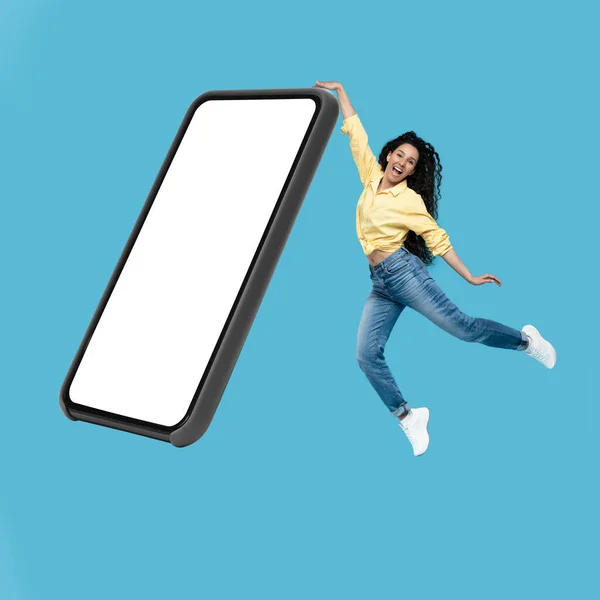 Joyful Middle Eastern Woman Jumping Touching Big Cellphone Blank Screen — Foto Stock