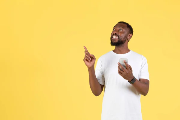 Look Excited African American Man Holding Phone Pointing Fingers Aside — Foto de Stock