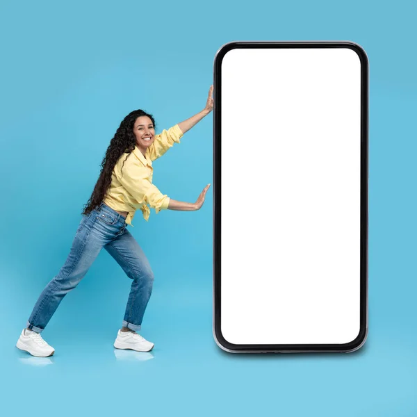 Happy Arabic Female Posing Pushing Cellphone Large Empty Screen Blue — Stockfoto