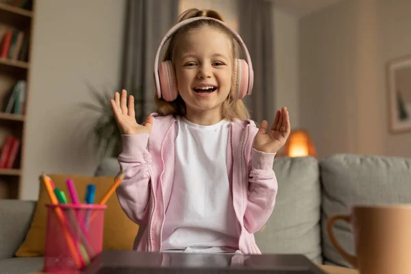 Learning Cheerful Schoolgirl Laughing Video Calling Wearing Headphones Sitting Laptop — Stockfoto