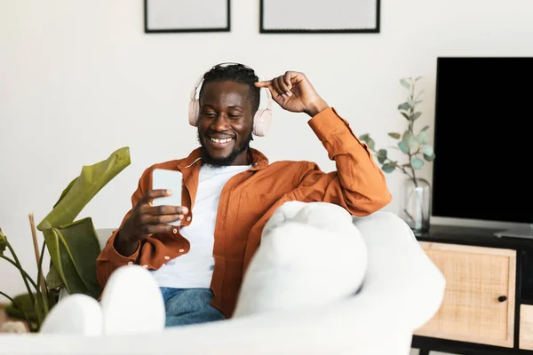 Excited Black Guy Headphones Enjoying Music Smartphone Scrolling Social Networks —  Fotos de Stock