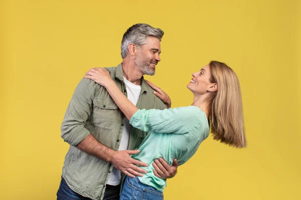 Loving Middle Aged Woman Her Husband Dancing Having Fun Yellow — Fotografia de Stock