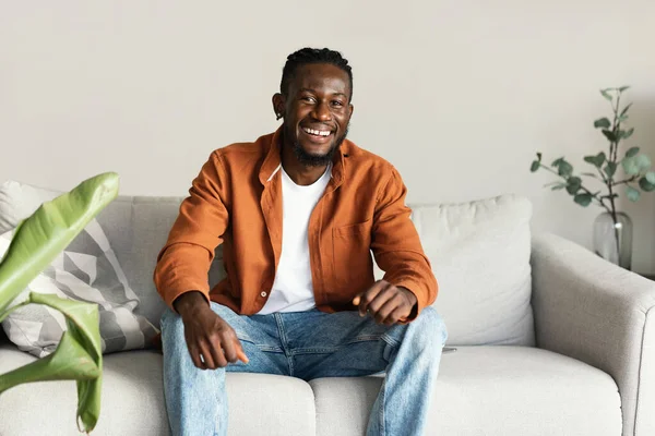 Portrait Handsome African American Man Smiling Looking Camera Sitting Sofa — Fotografia de Stock