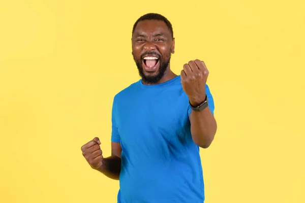 Emotional African American Guy Shaking Fists Smiling Camera Standing Yellow —  Fotos de Stock