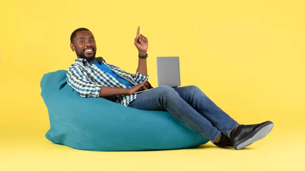Happy African American Guy Using Laptop Computer Sitting Beanbag Chair — стокове фото