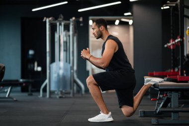 Portrait Of Athletic Black Man Making Bulgarian Split Squat Exercise At Gym, Motivated Young African American Male Training On Leg Muscles At Modern Sport Club, Enjoying Bodybuilding, Side View