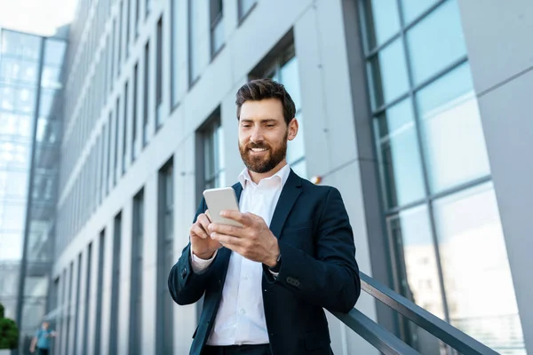 Confident Millennial Caucasian Businessman Beard Suit Typing Smartphone Chatting Surfing — Stock Fotó