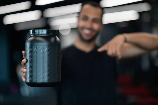 Black Sporty Male Demonstrating Blank Container Whey Protein Powder Pointing — Zdjęcie stockowe