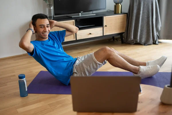 Happy Arab Man Working Abs Using Laptop Fitness Mat Home — Φωτογραφία Αρχείου