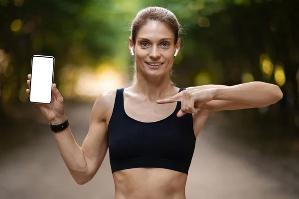 Positive Sporty Middle Aged Blonde Lady Showing Modern Smartphone White — Fotografia de Stock